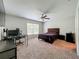 Comfortable bedroom with ceiling fan, a window for natural light, and carpeted floor at 3599 Caruso Pl, Oviedo, FL 32765