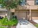 Inviting townhouse featuring a well-manicured lawn, attached garage, and neutral-toned exterior at 3599 Caruso Pl, Oviedo, FL 32765