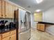 Kitchen featuring stainless steel appliances, oak cabinets, granite countertops and easy access to the doorway at 3599 Caruso Pl, Oviedo, FL 32765