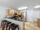 Modern kitchen with stainless steel appliances, granite countertops, and a breakfast bar with stools at 3599 Caruso Pl, Oviedo, FL 32765