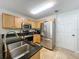 Efficient kitchen features stainless appliances, oak cabinets, and an open design for seamless meal preparation and socializing at 3599 Caruso Pl, Oviedo, FL 32765