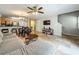 Comfortable living room boasts an open layout, a ceiling fan, and seamless access to the kitchen and staircase at 3599 Caruso Pl, Oviedo, FL 32765