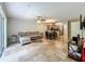 Spacious living area with tile flooring, a comfortable sectional sofa, and a seamless flow to the kitchen and dining area at 3599 Caruso Pl, Oviedo, FL 32765
