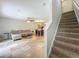 Open-concept living area with couch, dining table, tile floors, and staircase at 3599 Caruso Pl, Oviedo, FL 32765