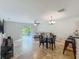 The combined living room, dining area, and kitchen create a cohesive and inviting space, with easy access to the outdoors at 3599 Caruso Pl, Oviedo, FL 32765