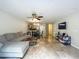 Open-concept living room features tile floors, a ceiling fan, and flows seamlessly into the kitchen and dining area at 3599 Caruso Pl, Oviedo, FL 32765
