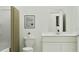 Bright bathroom featuring a modern vanity, framed art, and neutral-toned shower curtain at 373 Sol Vista Dr, Dundee, FL 33838