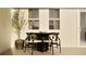 Bright dining area with a modern table and chairs near a window at 373 Sol Vista Dr, Dundee, FL 33838
