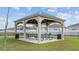 Charming community gazebo with picnic tables, ideal for outdoor gatherings and relaxing in the neighborhood at 373 Sol Vista Dr, Dundee, FL 33838