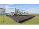 Community playground with swings, slide, and play structure, creating a fun and safe environment for children at 373 Sol Vista Dr, Dundee, FL 33838