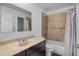 Bathroom featuring a vanity with an off-white countertop, and a tiled shower and tub combination at 3997 Versailles Dr # 3997F, Orlando, FL 32808