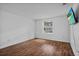 Bedroom featuring wood flooring and a flat screen television at 3997 Versailles Dr # 3997F, Orlando, FL 32808