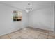 Dining area with tile floors, window with blinds, and a modern chandelier at 3997 Versailles Dr # 3997F, Orlando, FL 32808