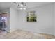 Bright dining area featuring tile floors, window with natural light, and glass sliding door access at 3997 Versailles Dr # 3997F, Orlando, FL 32808