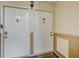 Condominium entrance featuring a welcome mat, two white doors with door knockers and unit numbers at 3997 Versailles Dr # 3997F, Orlando, FL 32808