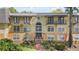 Multi-level condominium building featuring a symmetrical design and private balconies with black metal railings at 3997 Versailles Dr # 3997F, Orlando, FL 32808