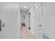 Bright hallway with ceramic tile flooring, featuring white walls, neutral doors, and recessed lighting at 3997 Versailles Dr # 3997F, Orlando, FL 32808
