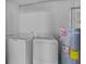 This laundry room contains a washer, dryer, and water heater at 3997 Versailles Dr # 3997F, Orlando, FL 32808