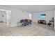 Open living area with ceramic tile flooring, white walls, modern furnishings, and natural lighting at 3997 Versailles Dr # 3997F, Orlando, FL 32808