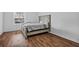 Bedroom with a large window, wood-look flooring, and a queen-size bed at 3997 Versailles Dr # 3997F, Orlando, FL 32808