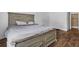 View of the main bedroom featuring wood floors and a large bed at 3997 Versailles Dr # 3997F, Orlando, FL 32808