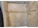 This tiled shower features a shower head and updated fixtures at 3997 Versailles Dr # 3997F, Orlando, FL 32808