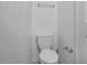 Close up of a standard white toilet in a small bathroom at 3997 Versailles Dr # 3997F, Orlando, FL 32808