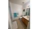 Well-lit bathroom featuring a bathtub, toilet, vanity with sink, and neutral-toned flooring at 4002 San Gallo Dr # 105, Kissimmee, FL 34741