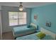 Bedroom with two twin beds, ceiling fan and window at 4002 San Gallo Dr # 105, Kissimmee, FL 34741