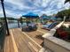 Community deck with lounge chairs, tables, and umbrellas overlooking the water at 4002 San Gallo Dr # 105, Kissimmee, FL 34741