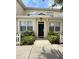Charming townhome entrance featuring a black door, white trim, and well-maintained landscaping at 4002 San Gallo Dr # 105, Kissimmee, FL 34741