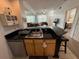 Open concept kitchen with breakfast bar leading into the living area, offering a seamless flow for entertaining at 4002 San Gallo Dr # 105, Kissimmee, FL 34741