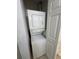 White stacked washer and dryer units in a laundry closet at 4002 San Gallo Dr # 105, Kissimmee, FL 34741