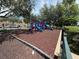 Community playground with slides, climbing structures, and wood chip ground cover at 4002 San Gallo Dr # 105, Kissimmee, FL 34741