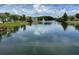 Calm pond featuring a fountain, lush landscaping, and nearby docks at 4002 San Gallo Dr # 105, Kissimmee, FL 34741