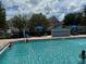 Sparkling swimming pool with shallow entry, fountain feature, and lounge chairs at 4002 San Gallo Dr # 105, Kissimmee, FL 34741