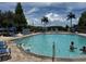 Inviting community pool with fountain, beach ball, and lounge chairs at 4002 San Gallo Dr # 105, Kissimmee, FL 34741
