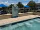 Outdoor spa tub with rules signage and surrounding lounge area at 4002 San Gallo Dr # 105, Kissimmee, FL 34741