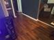 Wood floors offer charm and character in this hallway leading to living spaces at 4035 Nimons St, Orlando, FL 32811