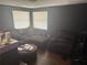 Cozy living room featuring dark walls, wood floors and comfortable seating area at 4035 Nimons St, Orlando, FL 32811