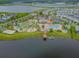 Aerial view features a community with a pool, splash pad, mini golf, kayak dock, and lake at 4367 Rhyme St, Kissimmee, FL 34746