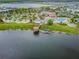 Aerial view features a community with a pool, splash pad, mini golf, kayak dock, and lake at 4367 Rhyme St, Kissimmee, FL 34746