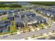 An aerial view of modern homes showcasing manicured lawns and swimming pools in a residential neighborhood at 4367 Rhyme St, Kissimmee, FL 34746