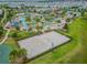Aerial showcasing a community's sand volleyball court and resort-style amenities, surrounded by lush landscaping at 4367 Rhyme St, Kissimmee, FL 34746