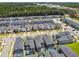 Aerial view of a modern housing community with swimming pools, green spaces, and well-maintained landscaping at 4367 Rhyme St, Kissimmee, FL 34746