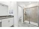 Bathroom featuring a walk-in shower, white cabinets, quartz countertops, and tile flooring at 4367 Rhyme St, Kissimmee, FL 34746