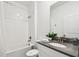Clean bathroom with a shower-tub combo, white tile, and a modern vanity with ample counter space at 4367 Rhyme St, Kissimmee, FL 34746