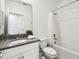 Clean bathroom features a shower-tub combo, white vanity, and modern fixtures at 4367 Rhyme St, Kissimmee, FL 34746