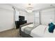 Bedroom featuring a platform bed with blue pillows, carpet flooring, and a flat screen television at 4367 Rhyme St, Kissimmee, FL 34746