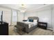 Bedroom with a large decorative light fixture, a modern platform bed, two side tables, and carpet flooring at 4367 Rhyme St, Kissimmee, FL 34746